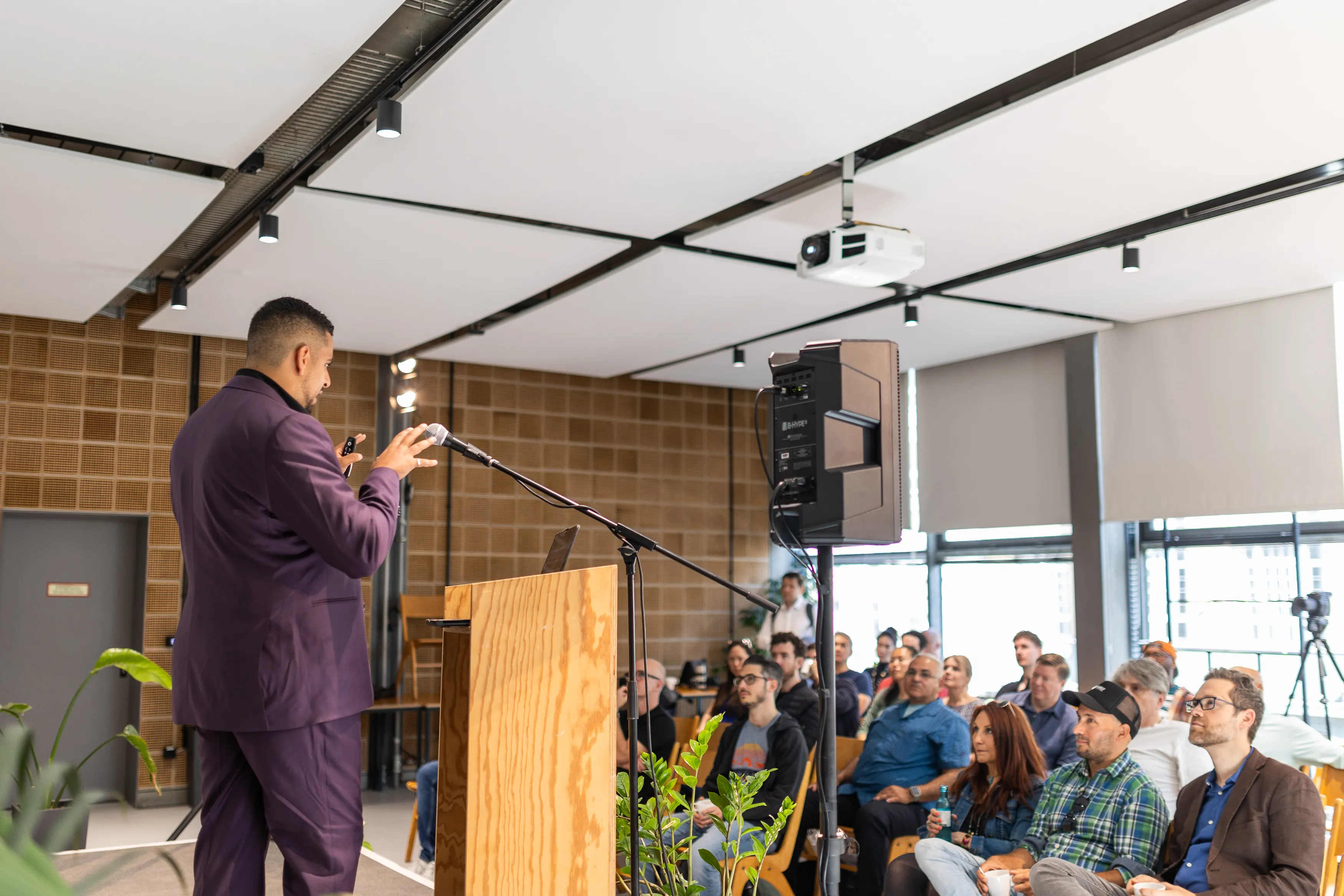 Mark at the podium, seen over the audience