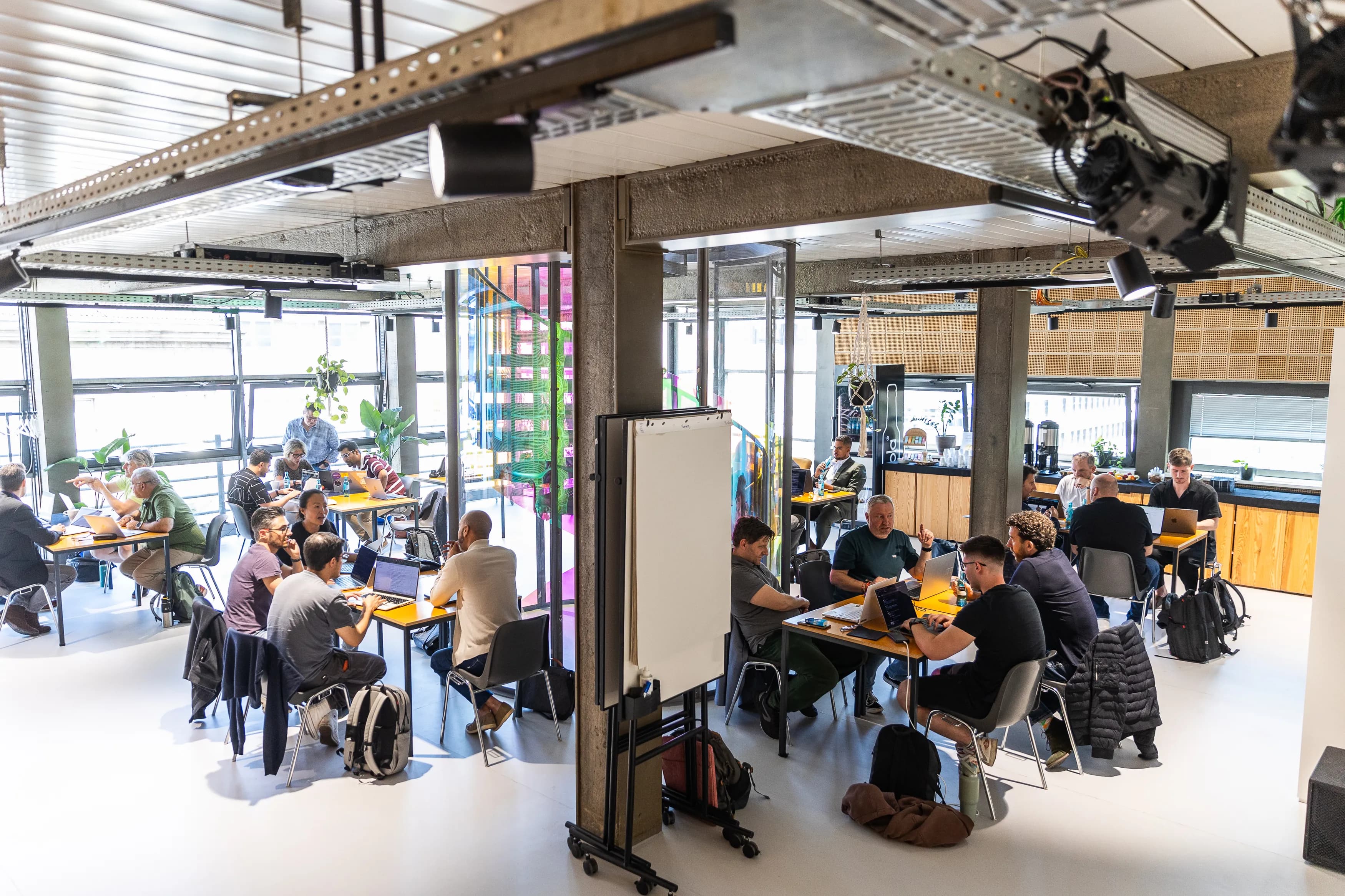 Teams building on laptops in the loft